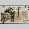 Man stands in front of farm fields (ddr-densho-359-1078)