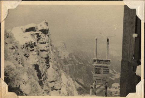 Rocky cliff and ski lift sign (ddr-densho-466-806)