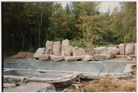 Pool with rock feature under construction (ddr-densho-377-2391)