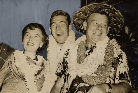 Two men and a woman wearing leis (ddr-njpa-1-486)