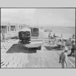 Japanese Americans unloading lumber for barrack construction (ddr-densho-37-858)