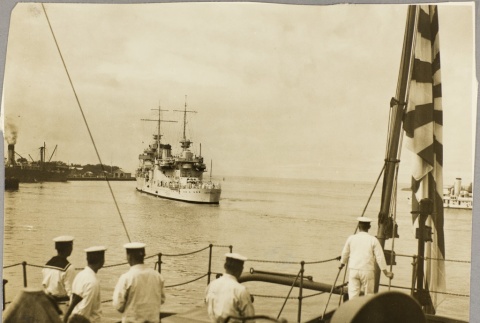 Sailors on another ship watching the USS Astoria entering a harbor (ddr-njpa-13-351)