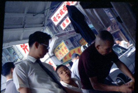 Two men and a boy at street market stall (ddr-densho-426-739)