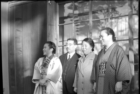 Man and three women outside building (ddr-densho-426-305)