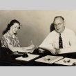 Man and woman sitting at a desk (ddr-njpa-2-471)