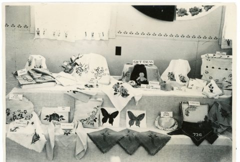 Photograph of gift ideas created at Manzanar and exhibited with other textiles (ddr-csujad-47-73)