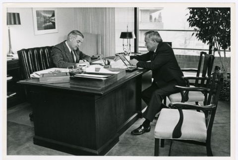 Frank Sato sitting with former Vice President Walter Mondale (ddr-densho-345-11)