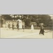 A group of men and women walking past a sentry (ddr-njpa-13-1436)