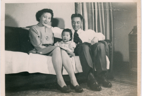 Mitsuko (Murakami) and Seigo Otani with daughter Pauline Otani sitting on couch (ddr-densho-467-1)