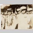 A man wearing leis, walking with soldiers (ddr-njpa-1-1267)