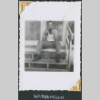 William Tsuchida sitting on steps eating watermelon (ddr-densho-434-227)