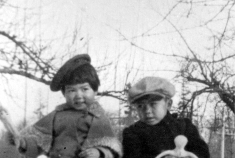 Two children sitting in the snow (ddr-densho-2-10)