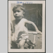 Toddler standing next to tricycle (ddr-densho-483-693)