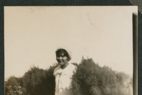 girl standing in bush (ddr-densho-378-695)
