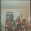 Chester and Agnes Sakura with man by Christmas tree holding presents (ddr-densho-523-466)