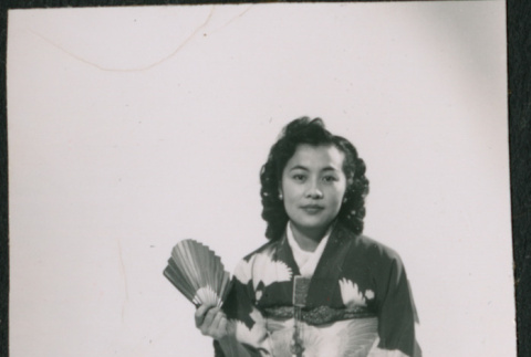 Portrait of woman sitting in kimono holding fan (ddr-densho-523-220)
