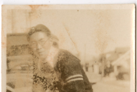 Man standing by car (ddr-densho-426-2149)