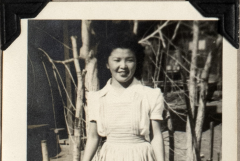 Woman standing by small trees (ddr-densho-587-19)