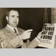 Man holding a newspaper titled 