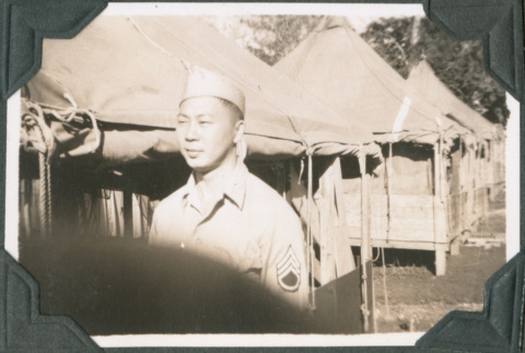 Man standing outside tents (ddr-ajah-2-577)