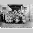 Group of women and three men posing for photo outside building (ddr-ajah-3-203)