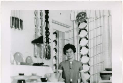 Tomoye Takahashi standing by product display at Gift Show (ddr-densho-426-1087)