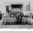 Group of men posing for photo outside of building (ddr-ajah-3-176)