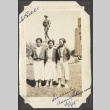 Three girls standing in front of a statue (ddr-densho-432-38)