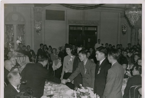 Men shaking hands at J.A.C.L. formal dinner (ddr-densho-201-457)