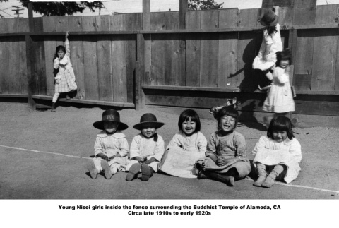 Group of young girls in fenced yard (ddr-ajah-3-196)