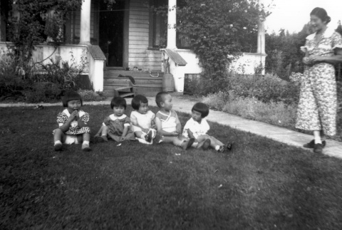 Family outside their home (ddr-densho-34-101)