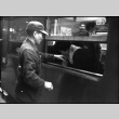 Man standing outside train window (ddr-densho-426-2301)