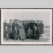 Group of Japanese American men, women, and children with coats and blankets (ddr-densho-362-32)