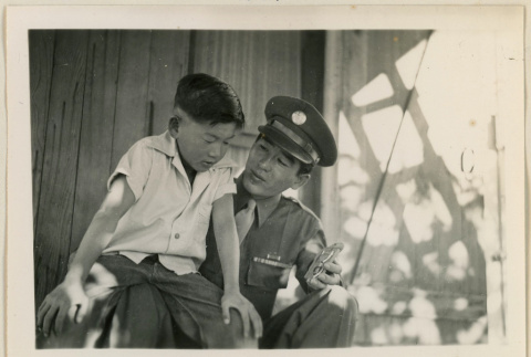 Sgt. Komoto holds his Purple Heart medal (ddr-densho-37-999)