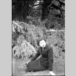 Tomoye (Nozawa) Takahashi sitting on  lawn (ddr-densho-426-2184)