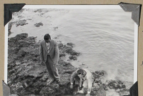 Two men in suits on a rocky beach (ddr-densho-404-271)