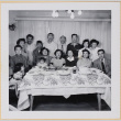 Group of adults and children posing by dinner table (ddr-densho-522-552)