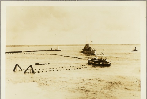 British navy ship passing a fishing boat in a harbor (ddr-njpa-13-593)