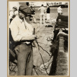 Man working on a fishing net (ddr-densho-542-783)
