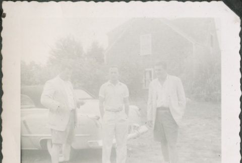 Three men standing by a car (ddr-densho-321-329)