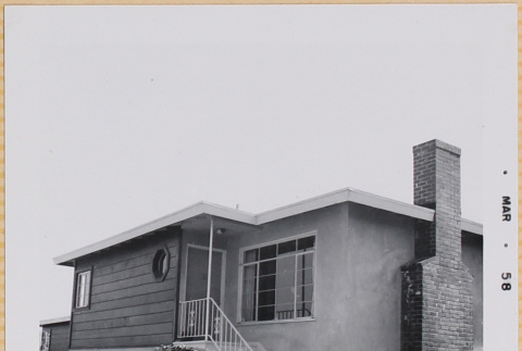 Man sitting on steps of house (ddr-densho-522-462)