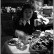 Tomoye (Nozawa) Takahashi at table eating (ddr-densho-426-1699)