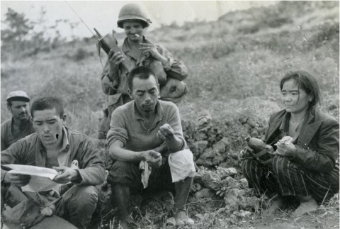 Okinawans holding American military leaflets (ddr-densho-179-2)