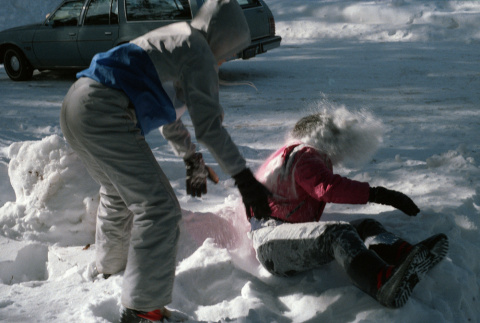 Stephanie Ide and Jon Osaki playing in the snow (ddr-densho-336-1564)