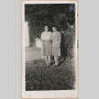 Two women standing in front of a house (ddr-manz-10-99)