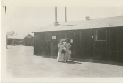 Two women standing in front of barracks (ddr-manz-7-10)