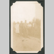 Group photo of five people on a dirt road (ddr-densho-483-183)