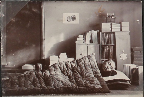 Japanese man lying in bed Japanese style (ddr-densho-259-35)