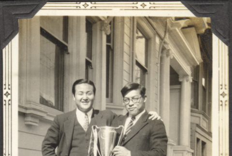 Two men holding a trophy (ddr-densho-326-528)