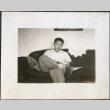 A young man sitting on a couch (ddr-densho-298-110)